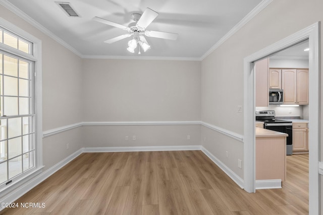 unfurnished room with light wood-type flooring, crown molding, a healthy amount of sunlight, and ceiling fan