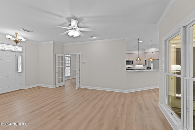 unfurnished living room featuring light wood-type flooring, ceiling fan with notable chandelier, and ornamental molding