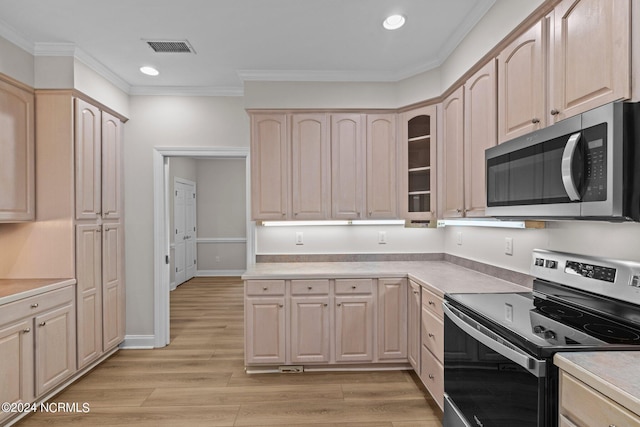 kitchen with appliances with stainless steel finishes, light brown cabinets, ornamental molding, and light hardwood / wood-style flooring