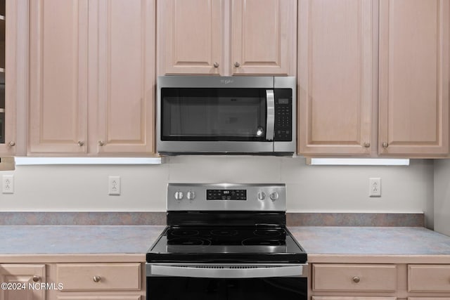 kitchen featuring light brown cabinetry and stainless steel appliances