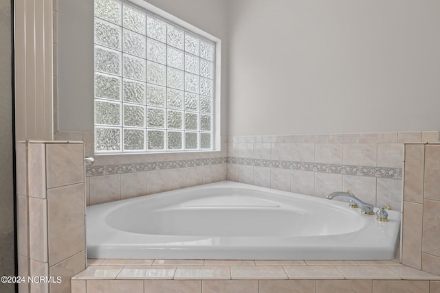 bathroom with tiled bath