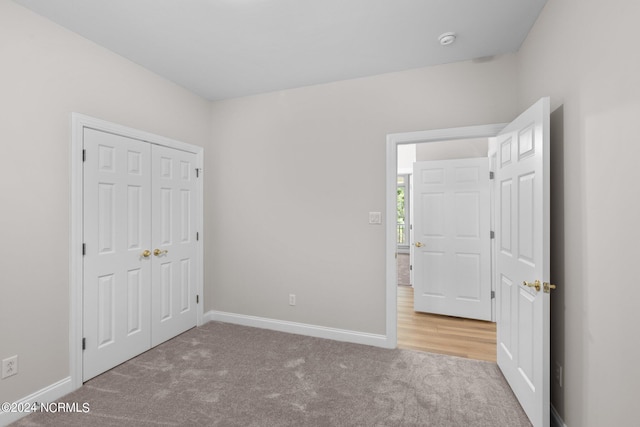 unfurnished bedroom featuring a closet and carpet flooring