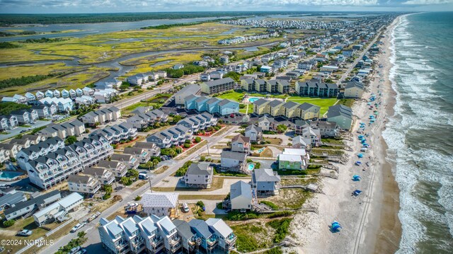 birds eye view of property with a beach view and a water view