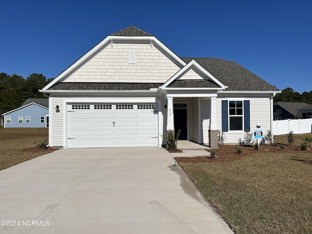 view of front of property with a front yard and a garage