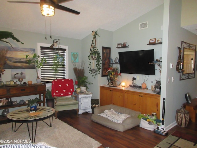 living room with dark hardwood / wood-style floors, ceiling fan, and vaulted ceiling