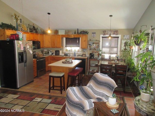 kitchen featuring a center island, black appliances, sink, and pendant lighting