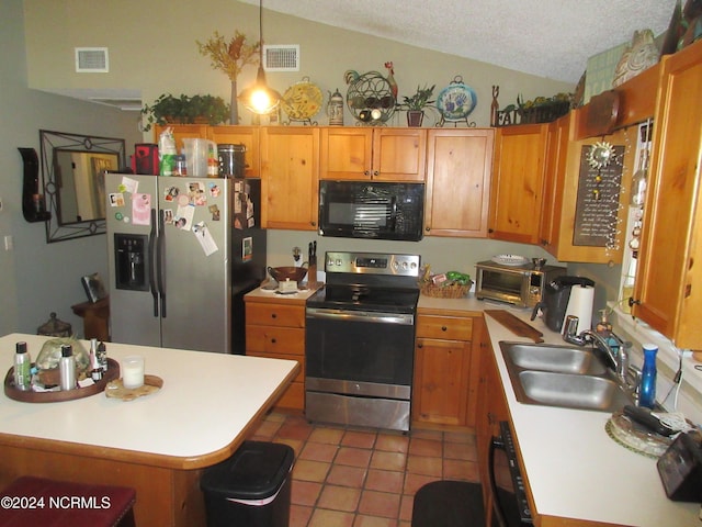 kitchen featuring tile patterned flooring, stainless steel appliances, vaulted ceiling, and sink