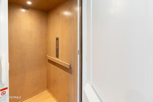 room details with wood-type flooring and elevator