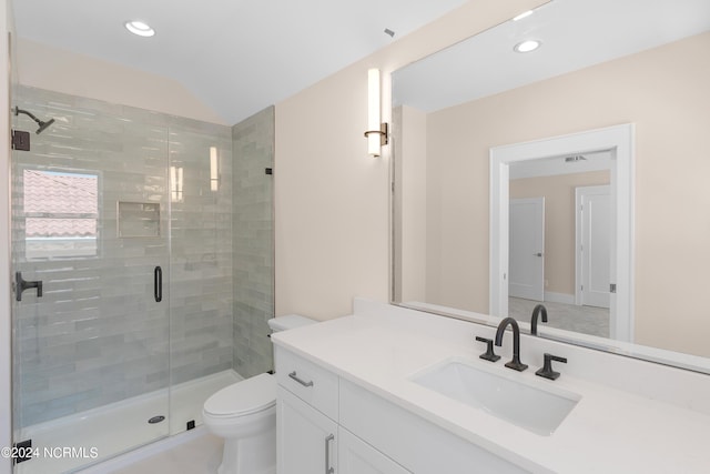 bathroom with vanity, toilet, a shower with shower door, and lofted ceiling