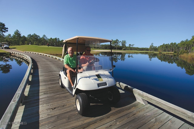 view of dock featuring a water view and a lawn