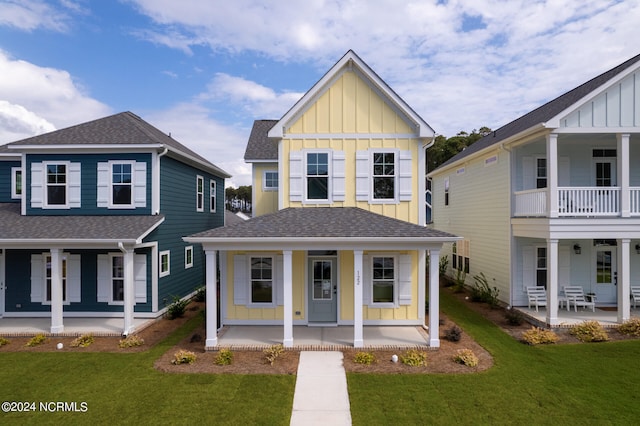 view of front facade with covered porch and a front yard