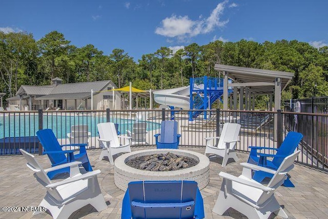 view of patio / terrace with a community pool and a fire pit