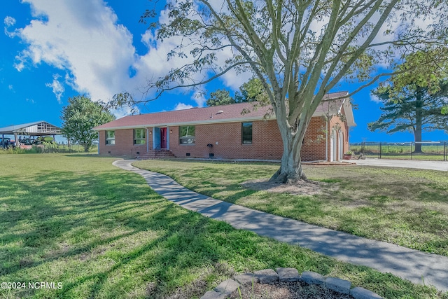 single story home featuring a front yard