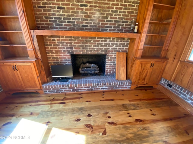 room details with hardwood / wood-style floors and a fireplace