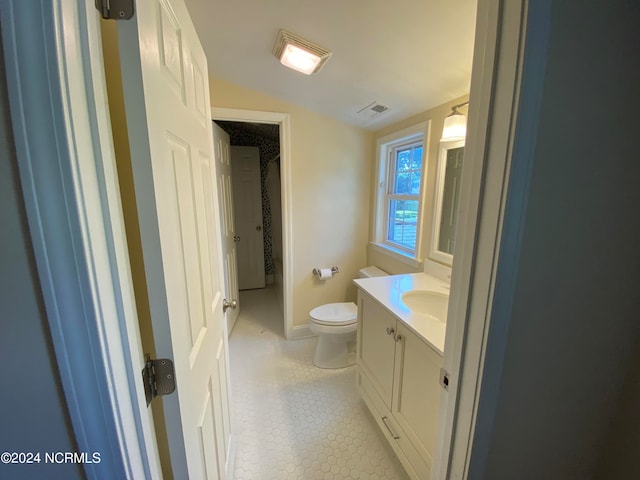 bathroom with vanity, toilet, and tile patterned flooring