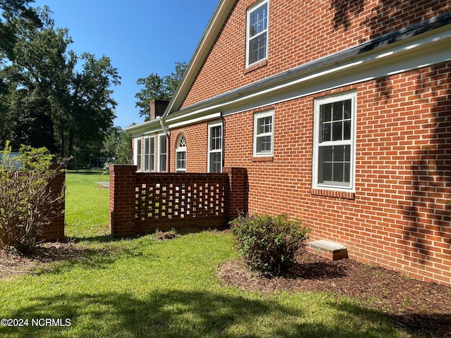 view of side of home featuring a yard