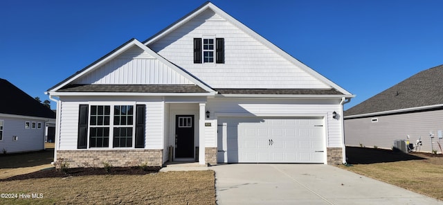 craftsman house with a front yard and cooling unit