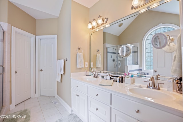 bathroom with tile patterned flooring, vaulted ceiling, a sink, and a shower stall