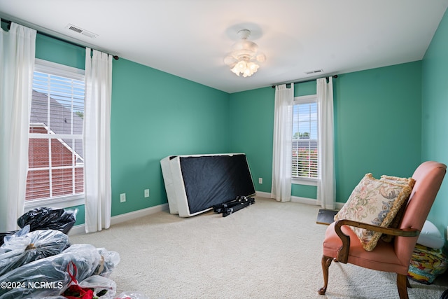 carpeted bedroom featuring visible vents and baseboards