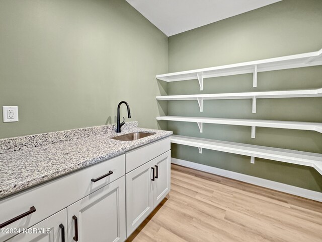 washroom featuring sink and light hardwood / wood-style flooring