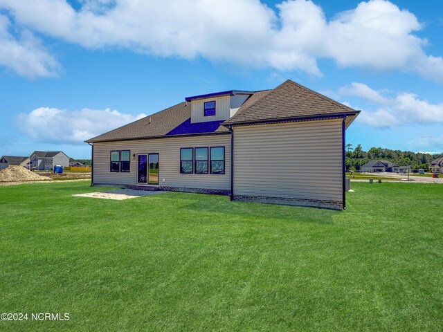 rear view of house with a lawn