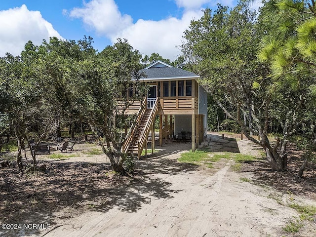 rear view of house featuring a sunroom