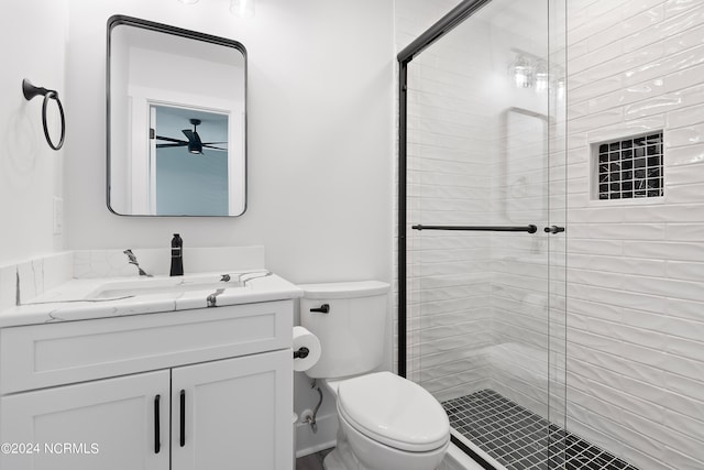 bathroom with vanity, toilet, and an enclosed shower