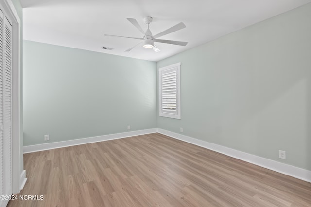 spare room featuring light wood-type flooring and ceiling fan