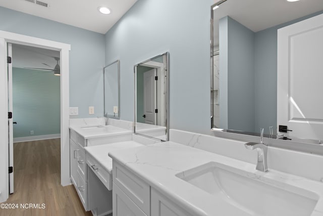 bathroom with hardwood / wood-style floors, vanity, and ceiling fan