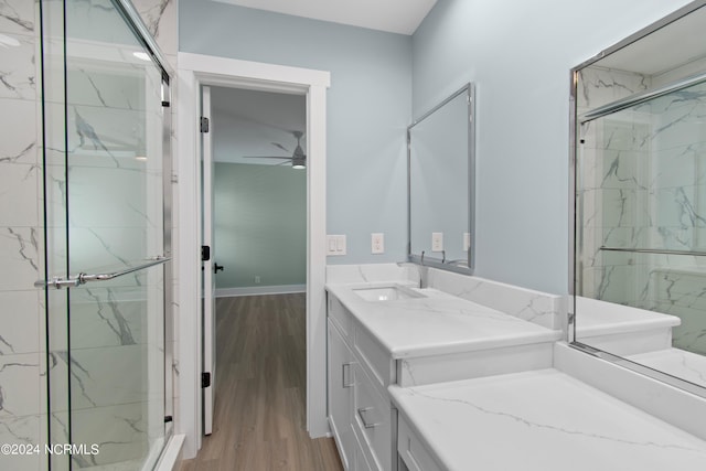 bathroom with vanity, ceiling fan, wood-type flooring, and walk in shower