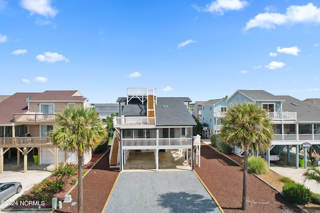 view of front of house featuring a balcony and a carport