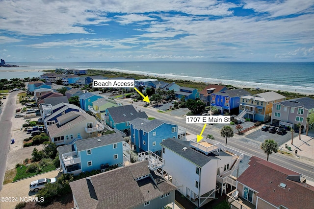 bird's eye view with a water view and a beach view