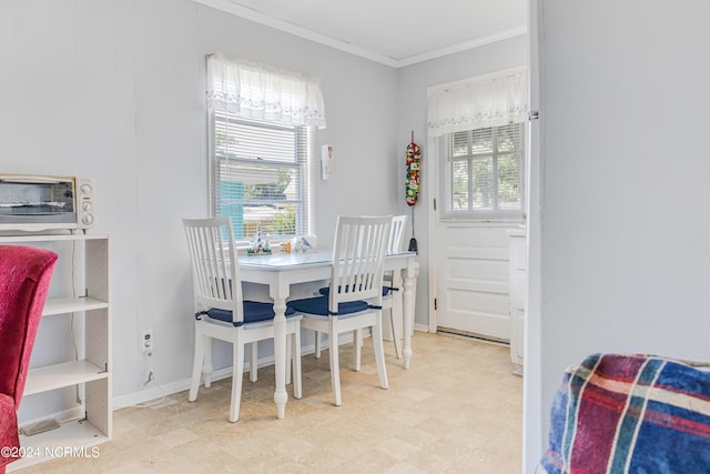 dining area featuring a healthy amount of sunlight and crown molding