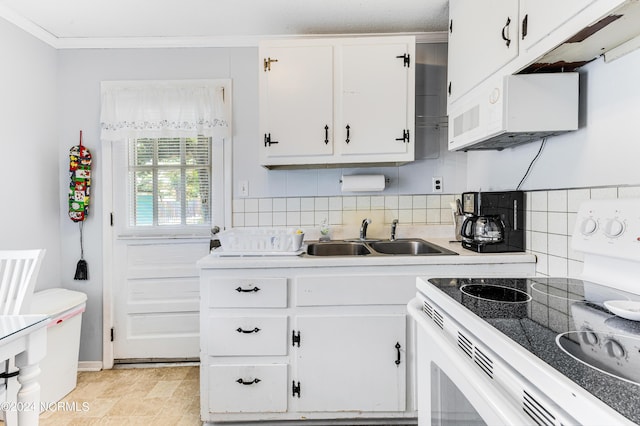 kitchen with light countertops, white appliances, white cabinets, and a sink