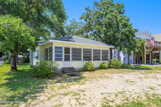 exterior space with a deck and a front lawn