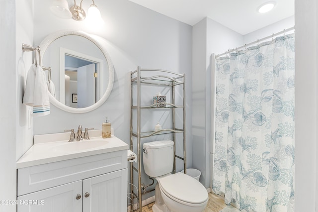 full bath with a shower with shower curtain, vanity, and toilet