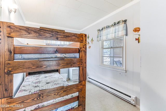 bedroom featuring a baseboard radiator, carpet flooring, and crown molding