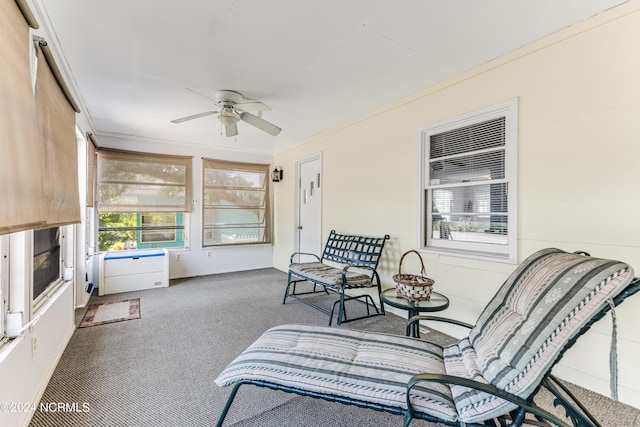 sunroom featuring ceiling fan