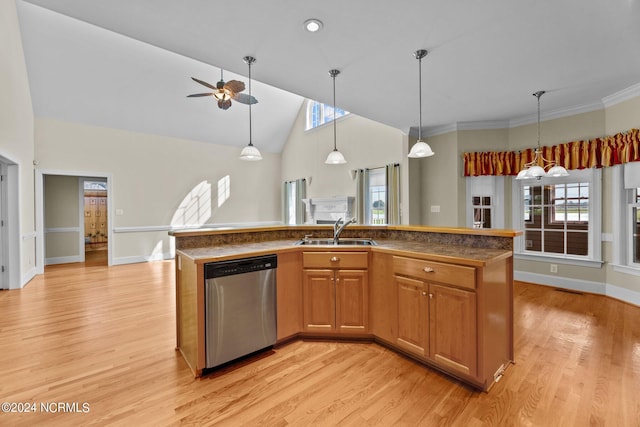 kitchen featuring pendant lighting, dishwasher, light wood-style flooring, and a sink