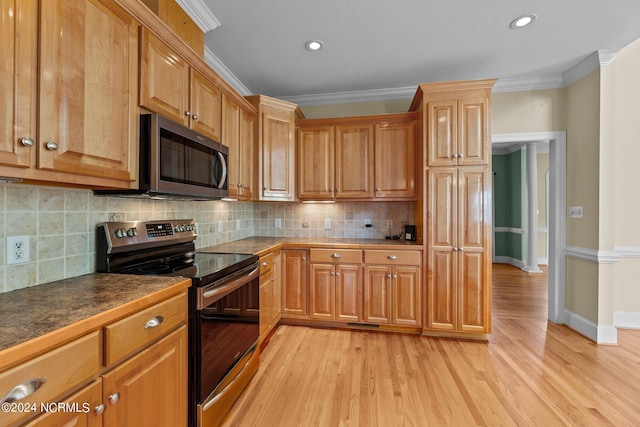 kitchen with appliances with stainless steel finishes, light wood-style floors, ornamental molding, and decorative backsplash