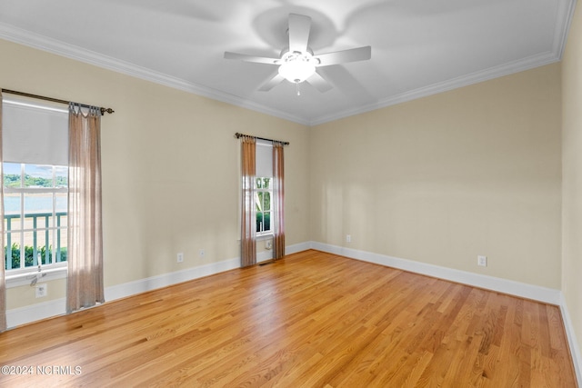 unfurnished room with baseboards, a ceiling fan, light wood-style flooring, and crown molding