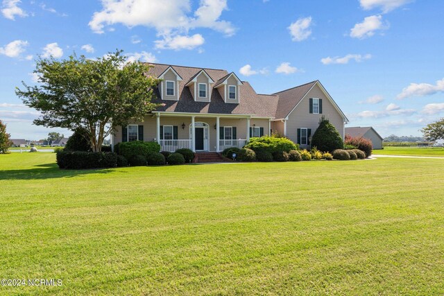 cape cod house featuring covered porch and a front yard