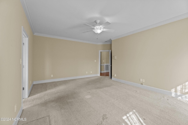 unfurnished room with ceiling fan, light carpet, visible vents, baseboards, and crown molding