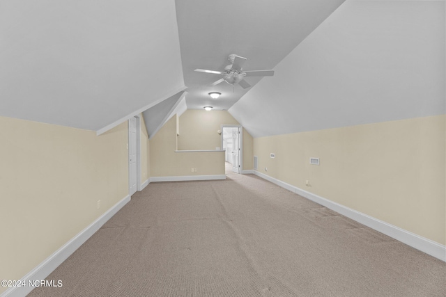 bonus room with a ceiling fan, vaulted ceiling, carpet floors, and baseboards