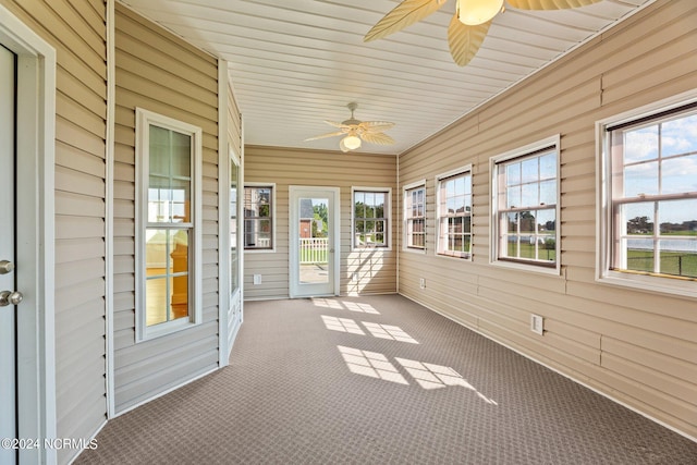 unfurnished sunroom featuring plenty of natural light and ceiling fan