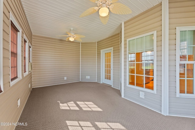 unfurnished sunroom with ceiling fan