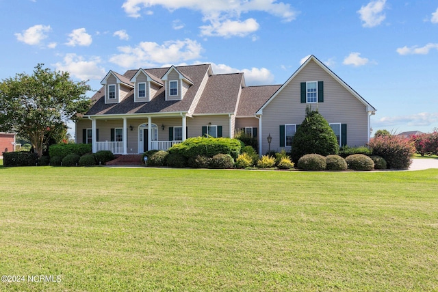 cape cod home with covered porch, roof with shingles, and a front lawn