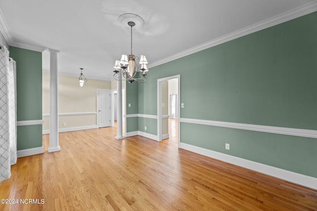 unfurnished dining area with ornate columns, light wood-style flooring, ornamental molding, and baseboards