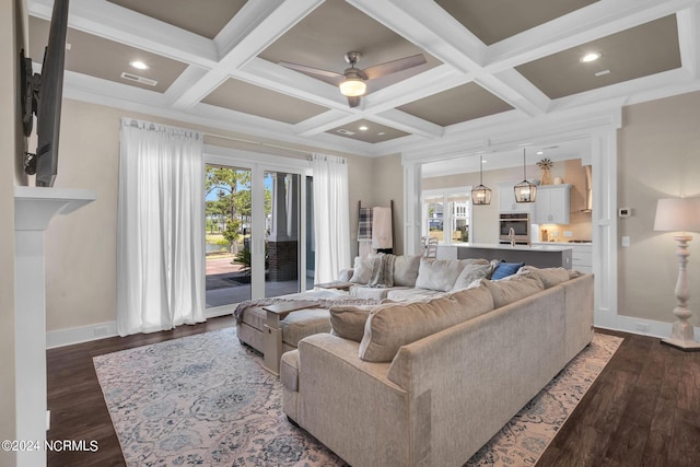 living room featuring coffered ceiling, beam ceiling, and hardwood / wood-style flooring