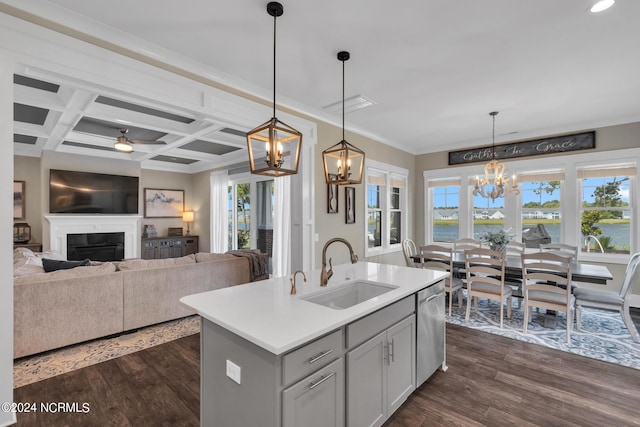 kitchen featuring coffered ceiling, an island with sink, a water view, and sink